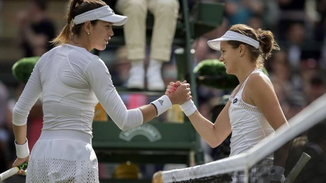 Jun 30, 2016; London, United Kingdom; Jana Cepelova (SVK) and Garbine Muguruza (ESP) at the net after their match on day four of the 2016 The Championships Wimbledon. Mandatory Credit: Susan Mullane-USA TODAY Sports